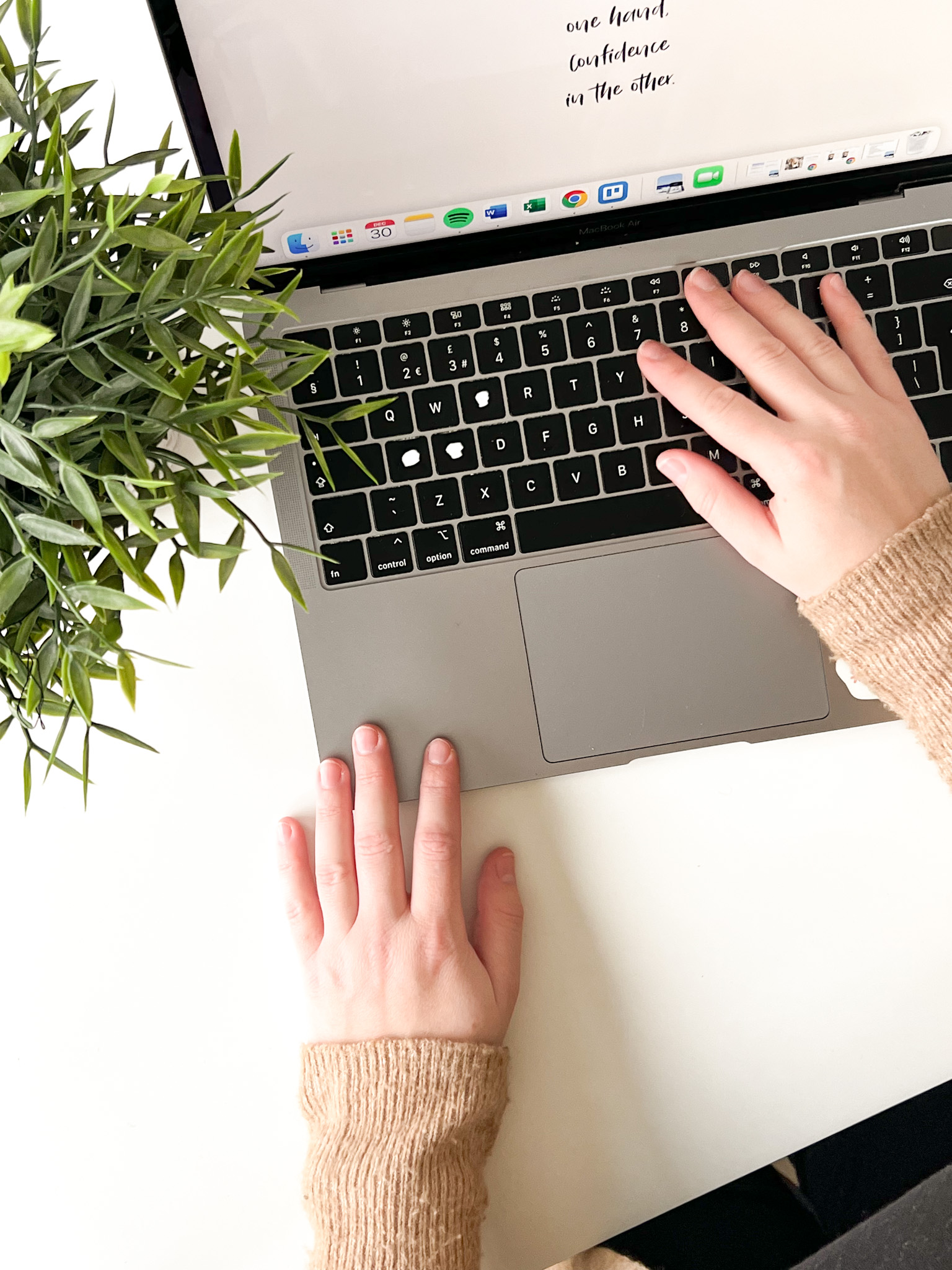 Sophie typing on her MacBook, strategising on an email marketing strategy